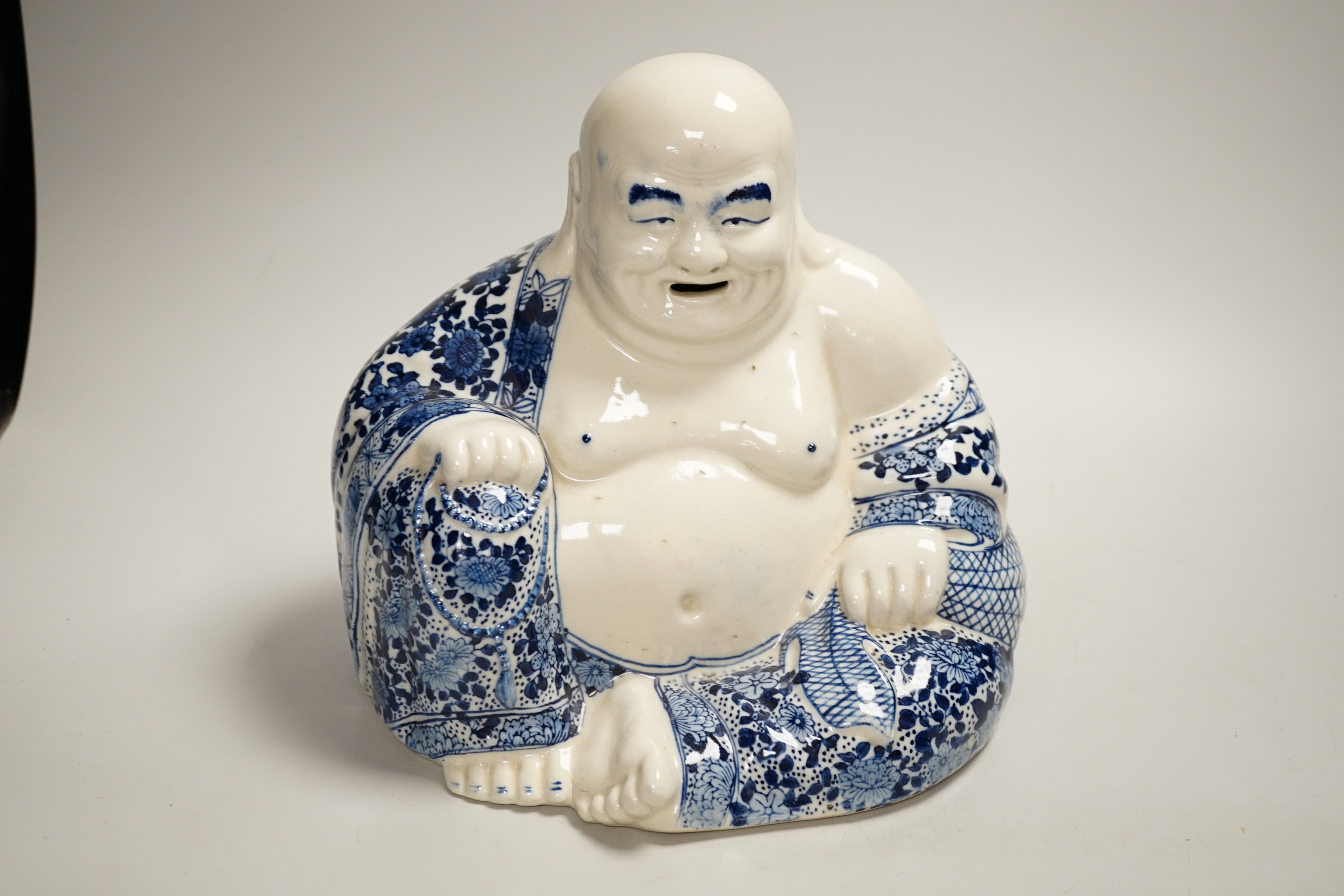 Chinese ceramics including a Buddha, prunus flower ginger jar and plates, the largest 26cm high